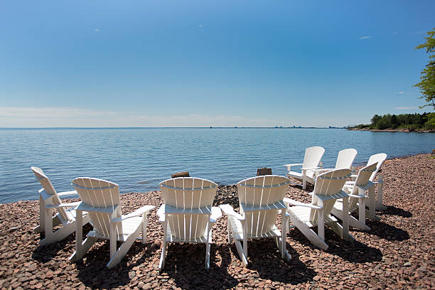 Adirondack chairs on a Minnesota lake shoreline