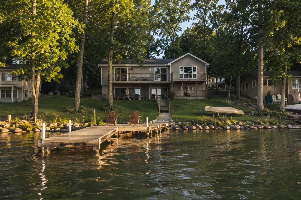 White farmhouse Minnesota lake estate marketed by MN Lake Homes